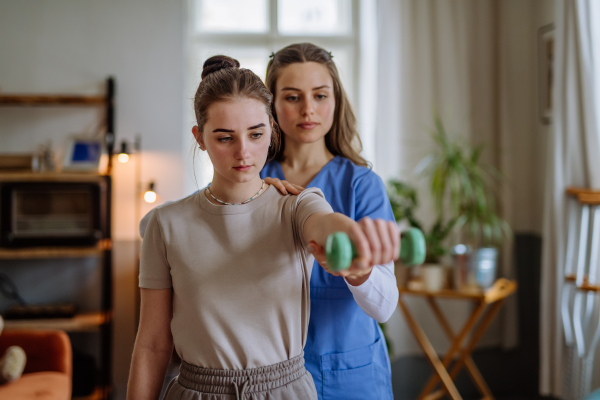 Teenage girl doing exercise with a physiotherapist.