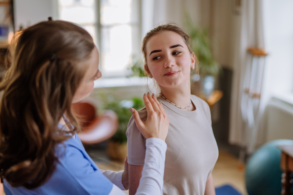 Teenage girl doing exercise with a physiotherapist.