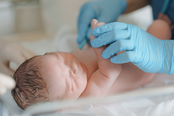 Neonatal nursers, doctor examining newborn baby, taking care of infant after birth. Neonatal care, newborn's health and well-being.