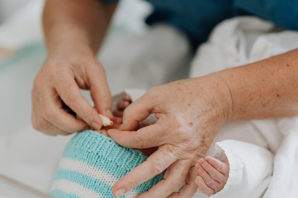 Neonatal nursers, doctor examining newborn baby, taking care of infant after birth. Neonatal care, newborn's health and well-being.