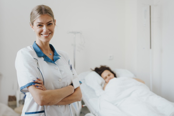 Lactation consultant helping with breastfeeding newborn baby, latching, feeding on first milk, colostrum. Happy mother bonding with newborn baby right after birth. Skin to skin contact.