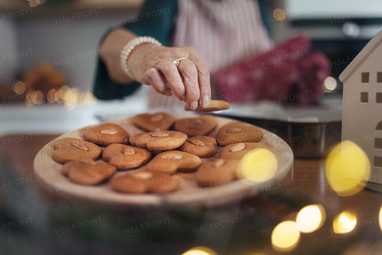 Close-up of senior woman baking gingerbreads.