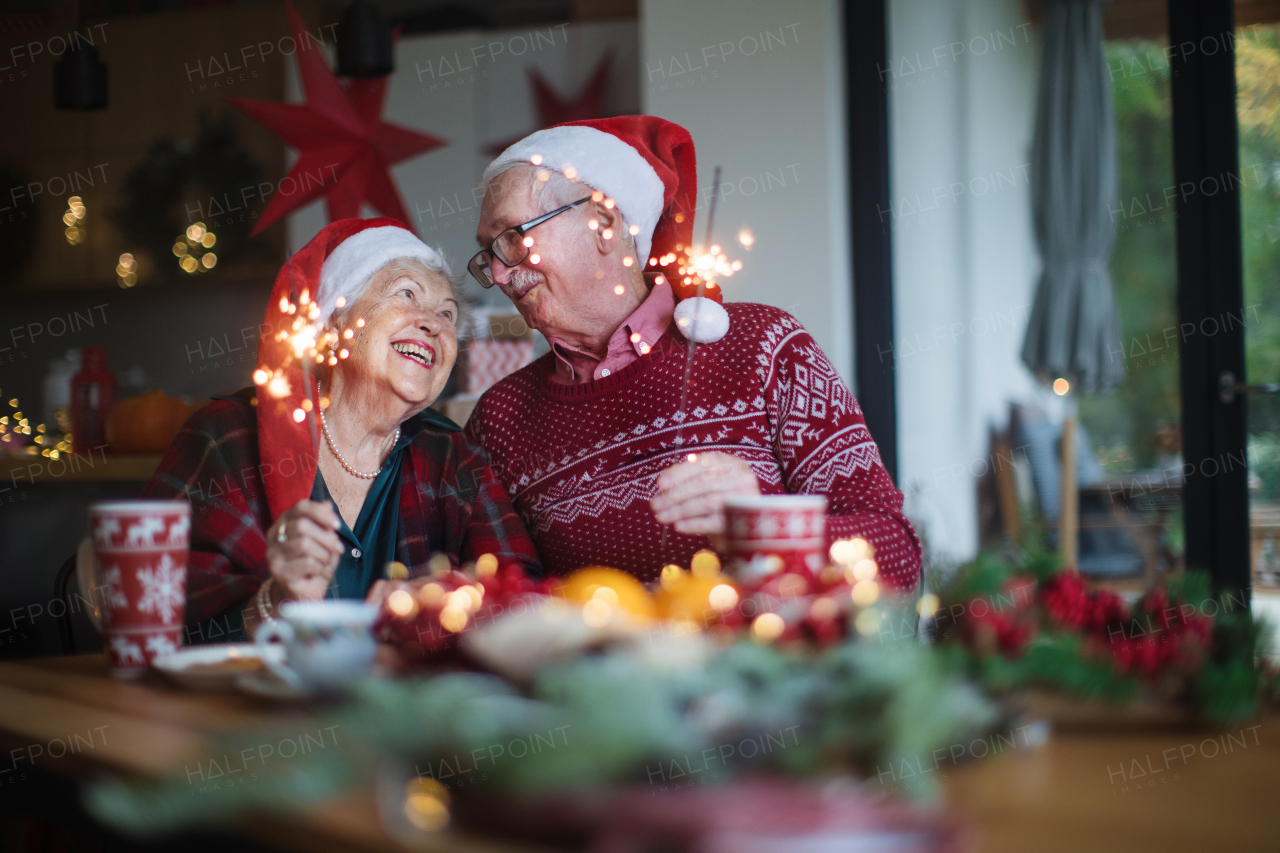 Happy senior couple celebrating New Year eve with sparklers.