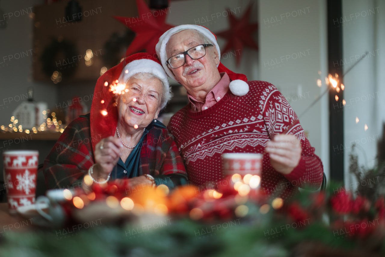 Happy senior couple celebrating New Year eve with sparklers.