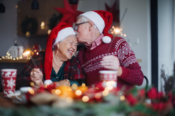 Happy senior couple celebrating New Year eve with sparklers.