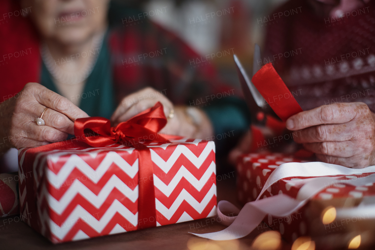 Senior couple preparing Christmas gifts for their family, close-up.