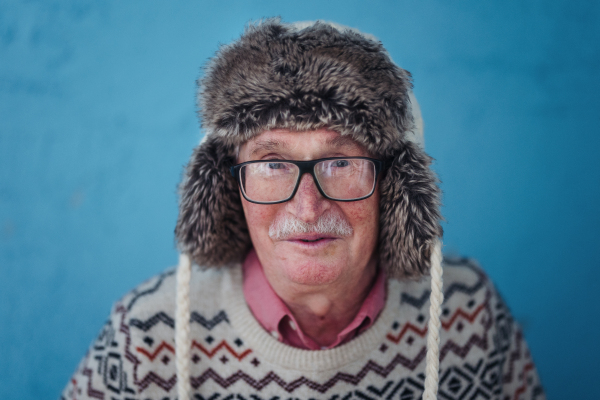 Portrait of happy, excited senior man in warm Chrstimas cap.