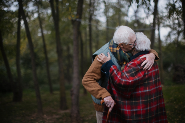 Senior couple hugging each other in autumn nature.