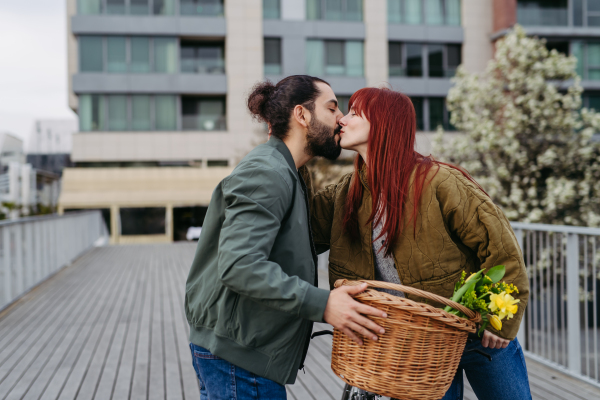 Girlfriend and boyfriend meeting in the city, greeting each other. Romantic date during cold spring day