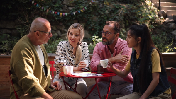 Video of group of friends taking a coffee break after volunteers meeting in their community space.