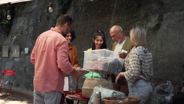 Video of volunteers sorting of clothes collected in a charity. Charitable work concept.