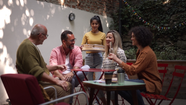 Video of group of friends spending time together in their volunteers community space., eating lunch.