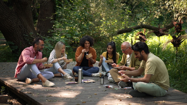 A group of friends taking a lunch break after volunteers meeting in their community space.