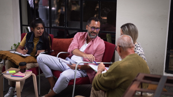 Video of group of volunteers planning charitable work in their community space.