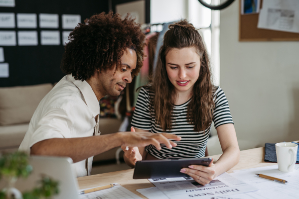 Young colleagues working together in a startup company.