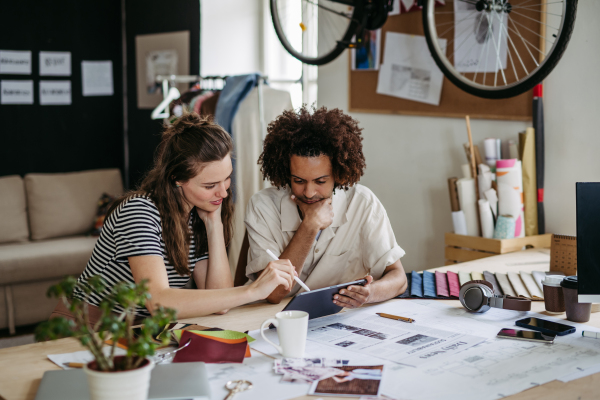 Young colleagues working together in a startup company.