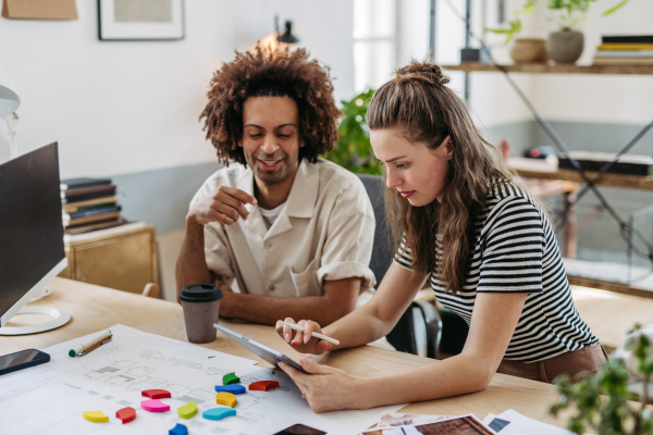 Young colleagues working together in a startup company.