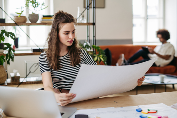 Young woman working in coworking office.