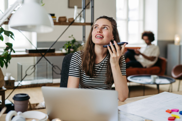 Young woman working in coworking office.