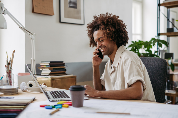 Young multiracial man working in a startup company.