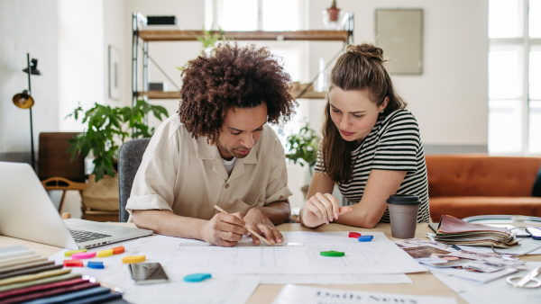 Young colleagues working together in creative atelier.