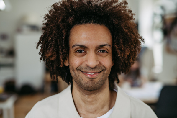 Portrait of young multiracial man in an office.