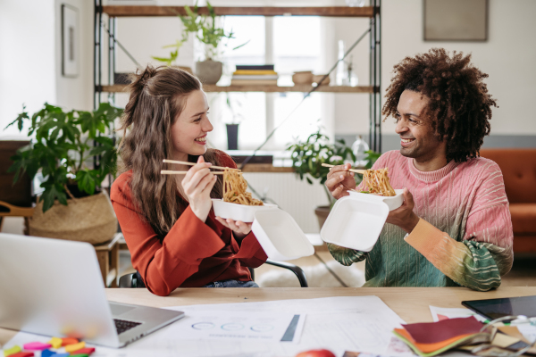 Young colleagues having lunch time in the office.