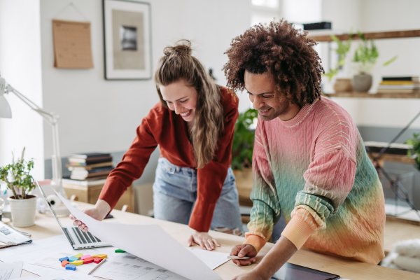 Young colleagues working together in a startup company.