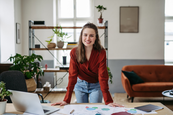 Portrait of young smiling woman in office.