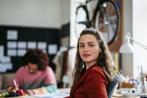 Portrait of young smiling woman in office.