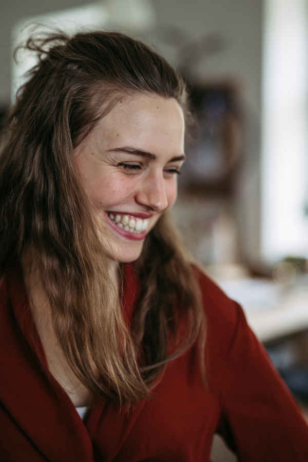 Portrait of young smiling woman in office.