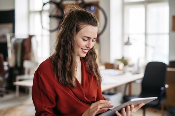 Portrait of young smiling woman in office.