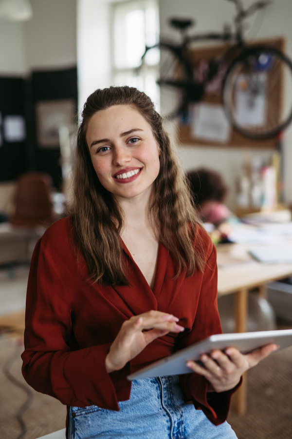 Portrait of young smiling woman in office.