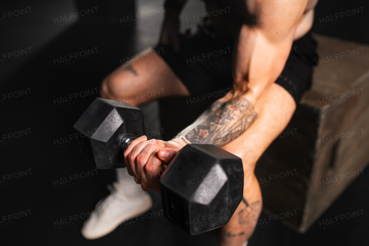 Man exercising with dumbells in one hand. Strength exercise. Routine workout for physical and mental health.