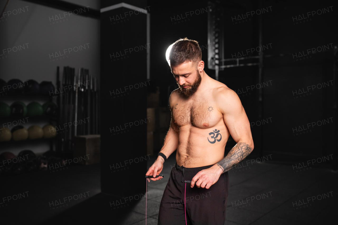 Handsome man jumping rope, doing double-unders as part of daily workout. Routine workout for physical and mental health.