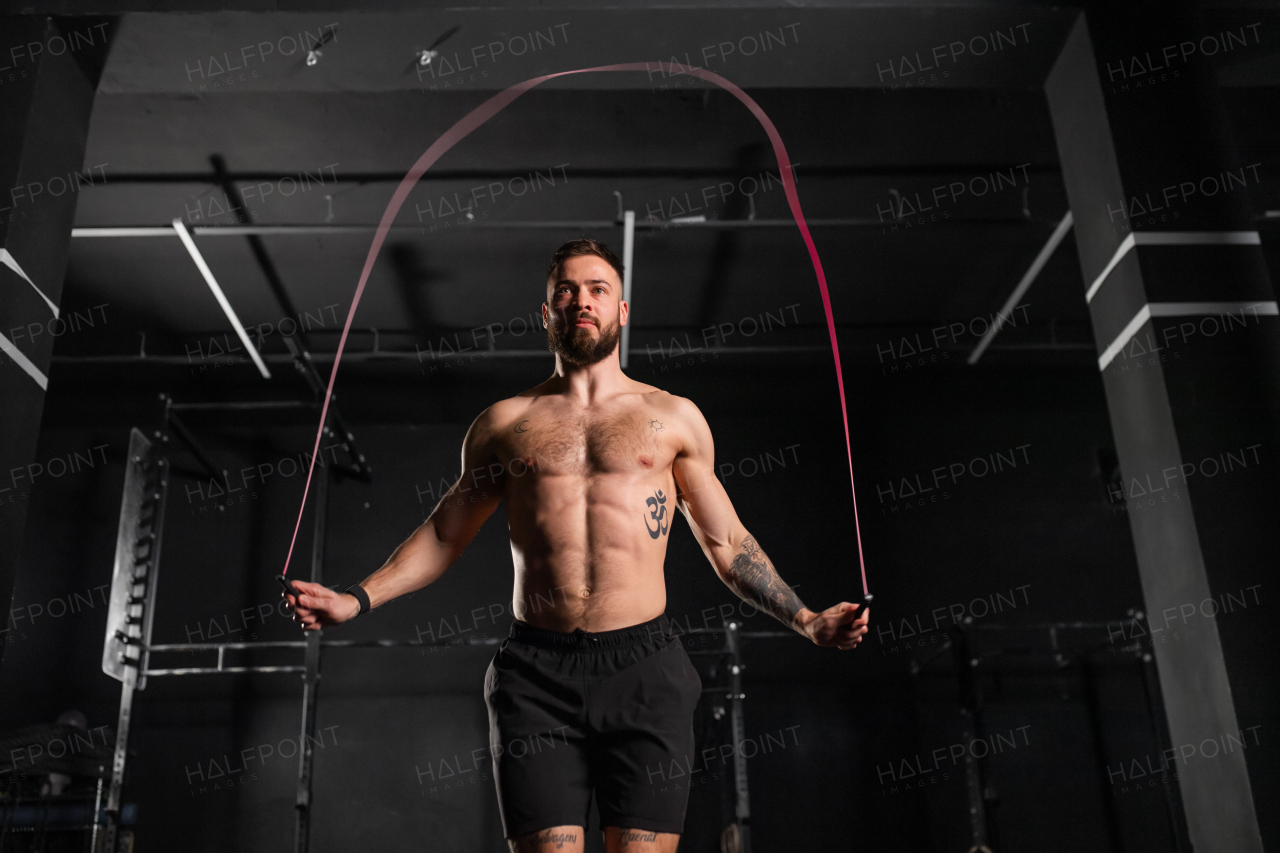 Handsome man jumping rope, doing double-unders as part of daily workout. Routine workout for physical and mental health.