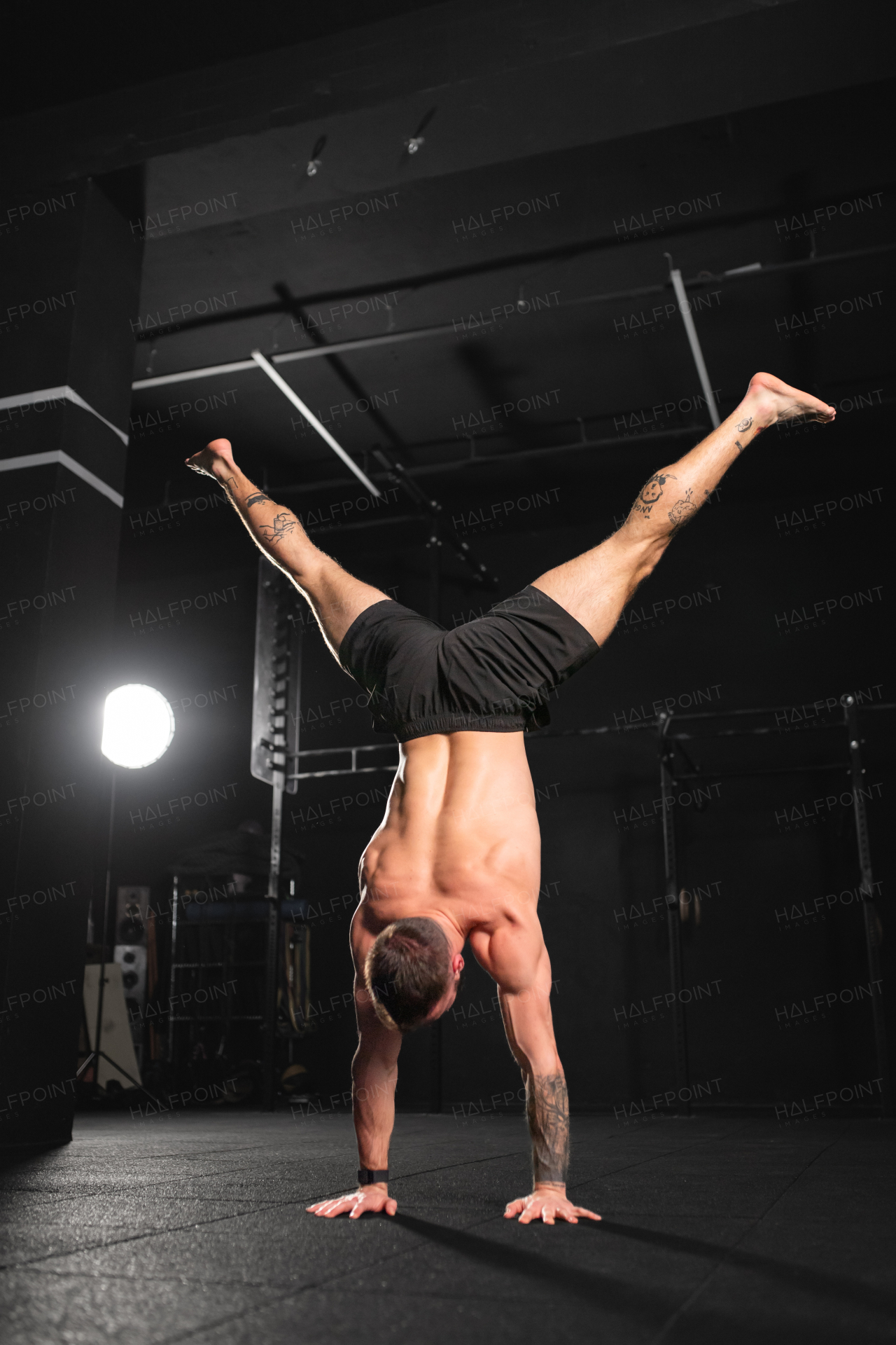 Rear view of handstand exercise, handstand push-ups by strong man. Vertical box jumps workout. Routine workout for physical and mental health.