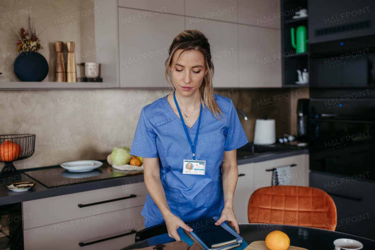 Female nurse, doctor getting ready for work, packing backpack, leaving house in scrubs with backpack. Work-life balance for healthcare worker.