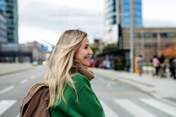 Nurse, doctor in uniform walking across city, going to work, hospital, clinic. Work-life balance of healthcare worker.