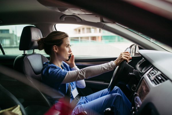 Female nurse going home from work, getting into car. Female doctor driving car to work, on-call duty, phone calling. Work-life balance of healthcare worker as parent and partner.