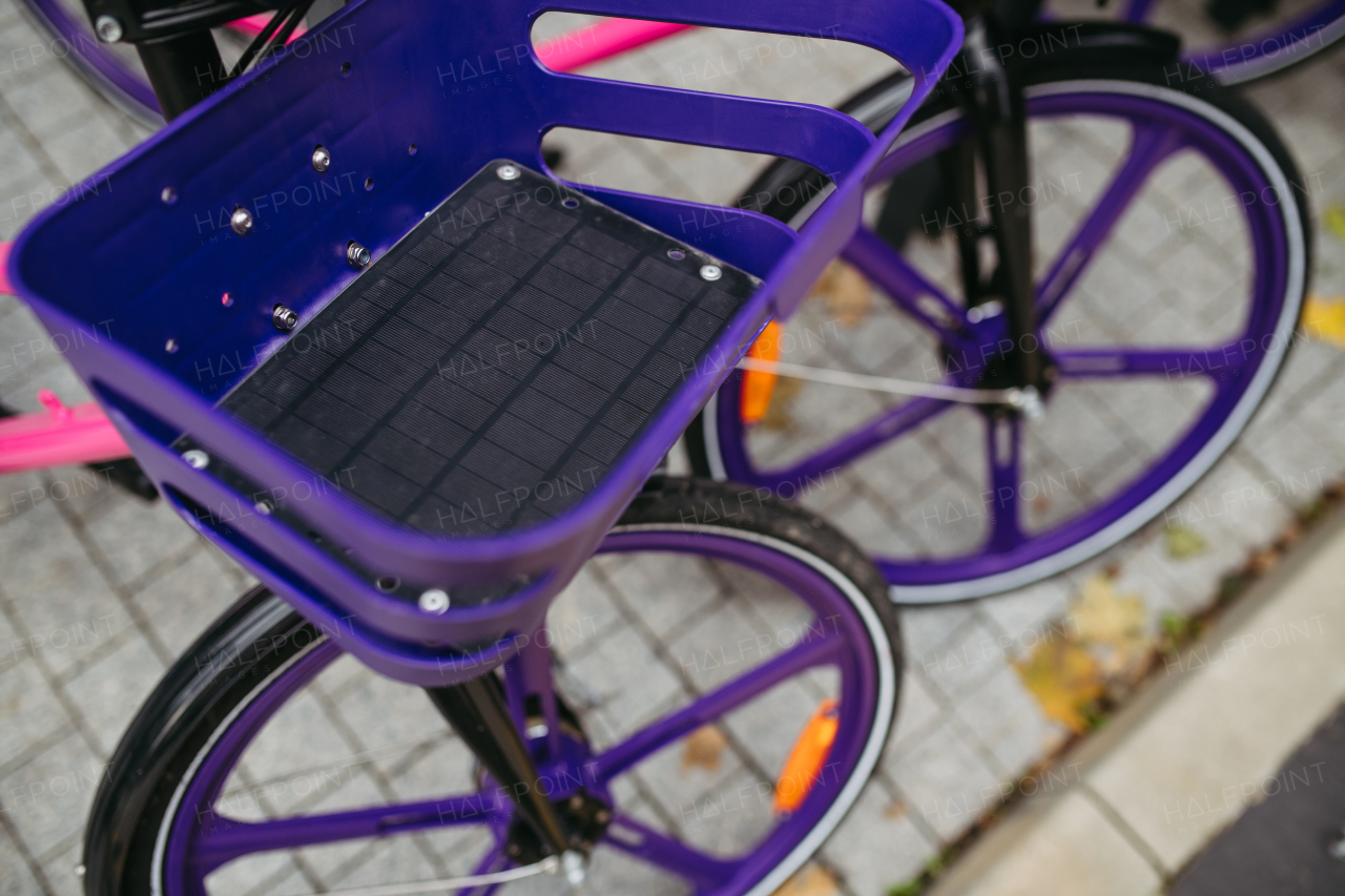 Close up of purple city bike with basket for rent.