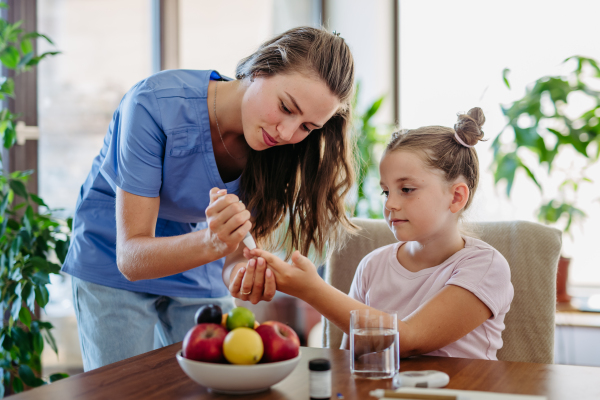 Nurse checking girl's blood glucose level using a fingerstick glucose meter. Endocrinologist waiting for results from his blood test.