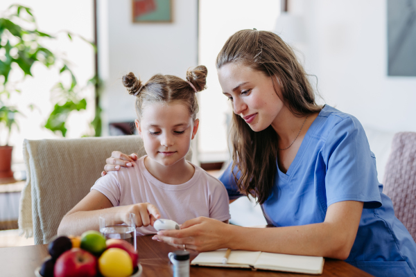 Nurse checking girl's blood glucose level using a fingerstick glucose meter. Endocrinologist waiting for results from blood test.