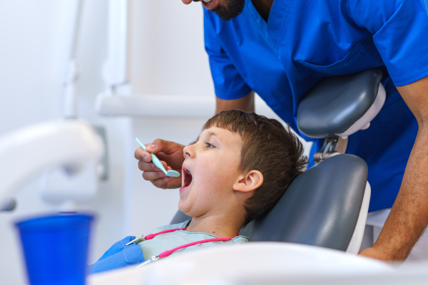 Portrait of a liitle boy during dentist examination.