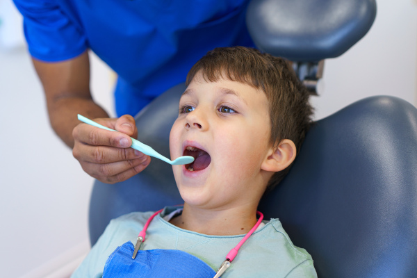 Portrait of a liitle boy during dentist examination.