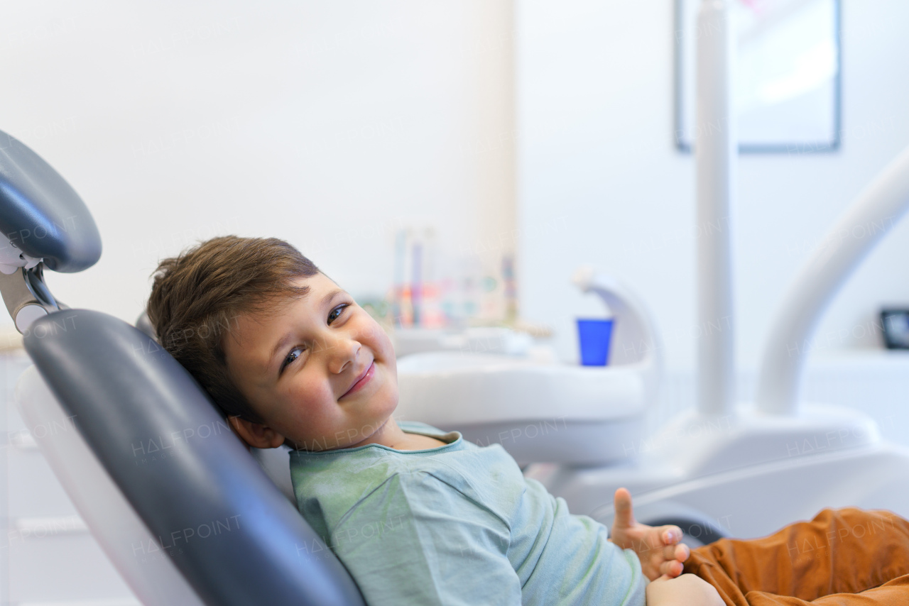 Portrait of little boy sitting on a dentist chair.