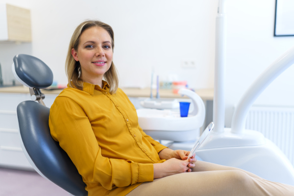 Portrait of young woman in a dentist chair.