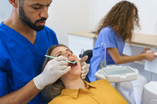 Dental examination of young woman at a dental clinic.