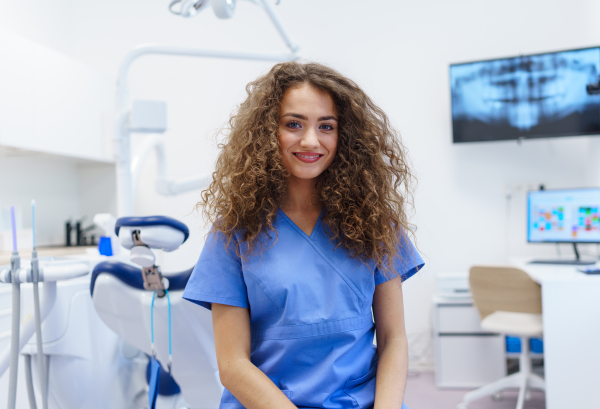 Portrait of young woman dentist at a private dental clinic.