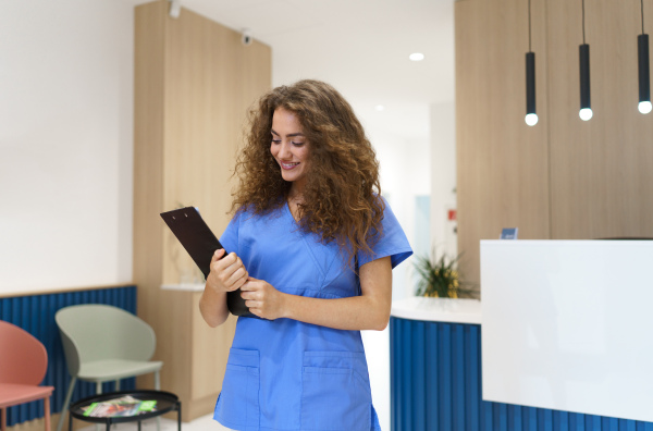 Portrait of dentist nurse posing at reception on a private dental clinic.